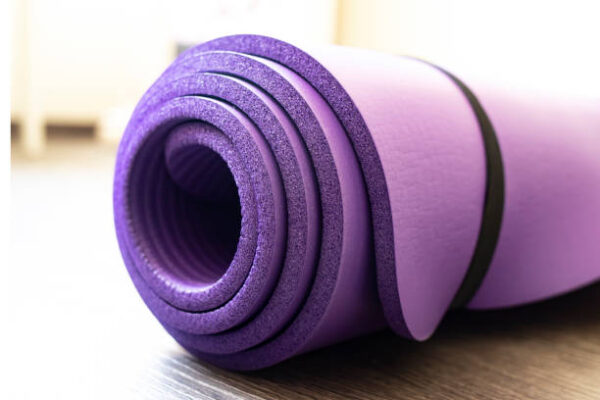 Mat for yoga and fitness on the floor. side view. healthy lifestyle concept.