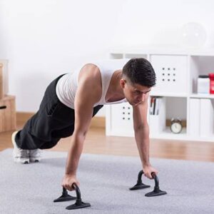 Attractive bodybuilder doing push ups in room
