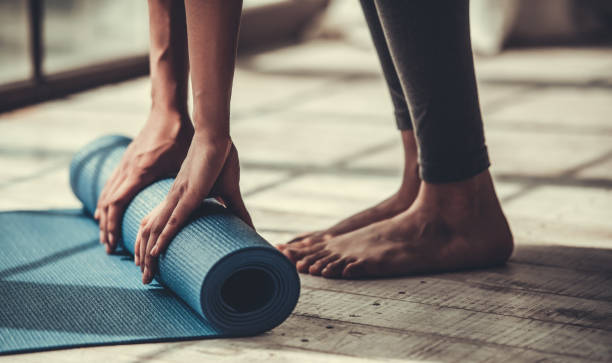 Cropped image of afro american rolling yoga mat